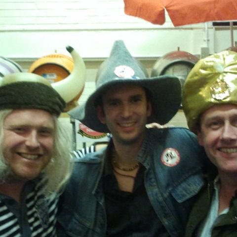 A row of friends in Viking helmets, gold party hats and a wizard hat