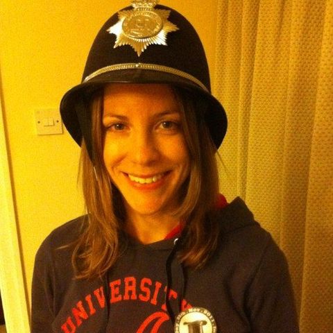 A woman in a police-style helmet with an IHD sticker on her jumper