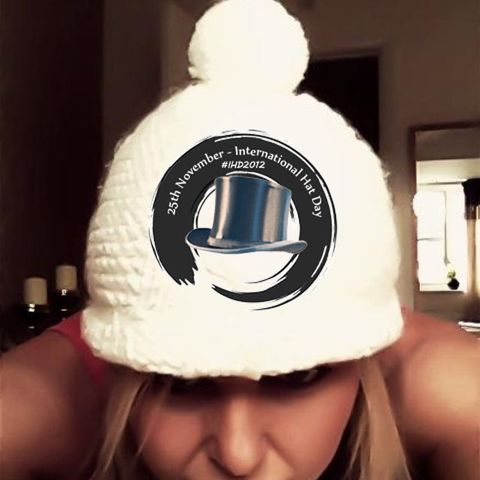 A woman in a big white bobble hat, peeking out beside the 2012 logo