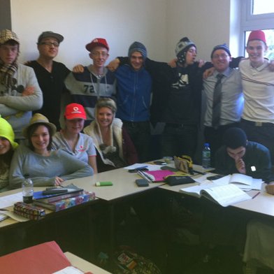 Group of Turton Media Arts College students and staff posing in assorted hats
