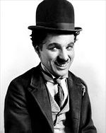 Charlie Chaplin as the Tramp, in a bowler hat