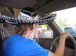 A driver in a hat behind the wheel